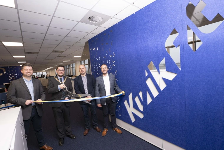 CEO of Kwik Fit, Mark Slade alongside Cllr Kenneth Duffy, Provost of North Lanarkshire and Dan Joyce, the Fleet Director of Kwik Fit cutting the ripon to officially open Kwik Fit's new Fleet support centre.